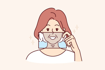 Woman demonstrates snow-white smile by applying glass to face and presenting result after whitening procedure at dentist. Young girl with beautiful smile represents own image in old age