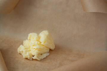 Beige background with a small piece of semi-hard cheese