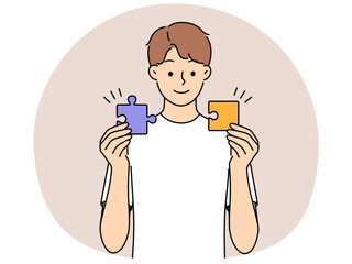 Smiling man connect jigsaw puzzles