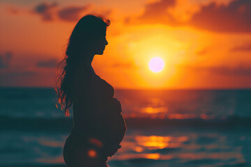 pregnant woman on the beach at sunset