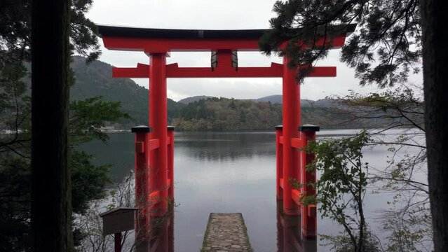 Hakone, Japan, flying through iconic torii gate on Lake Ashi. Hakone Shrine in Kanagawa Prefecture is one of the most famous shinto shrines in the area.	
