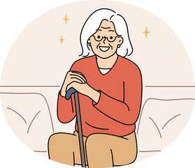 Smiling elderly grandmother sit on sofa