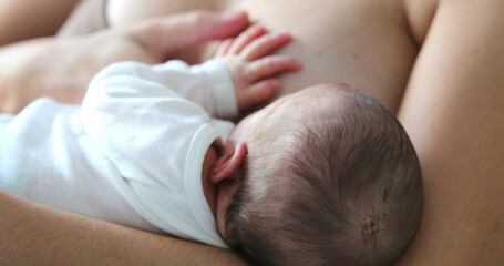 Obraz na płótnie Canvas Mom breastfeeding infant newborn baby