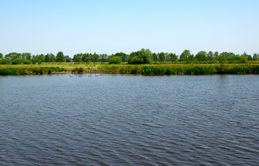 Landscape of a lake and blue sky reflected.