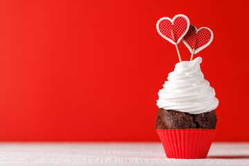 Cupcake love: Heart-themed treats on a vibrant red backdrop