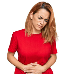 Hispanic young woman wearing casual red t shirt with hand on stomach because indigestion, painful illness feeling unwell. ache concept.