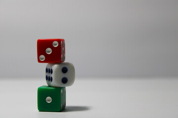 Close up of three different colored dice red, green, and white isolated on white background