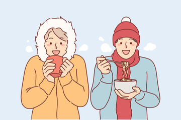 Frieds lunch standing under snow in winter clothes, trying to stay warm during december trip
