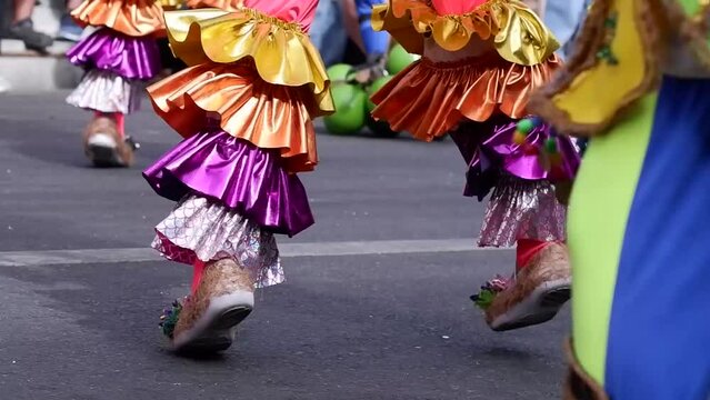 Street dancers in various local and colorful native costumes perform in a frenzy along the street to pay homage to a Patron Saint during the annual celebration of the coconut festival.