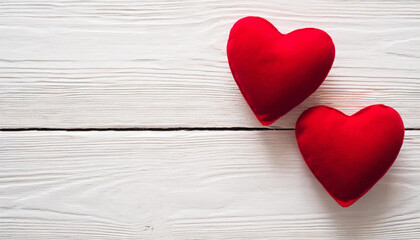 Fototapeta premium Valentines day background with two red hearts on white wooden table