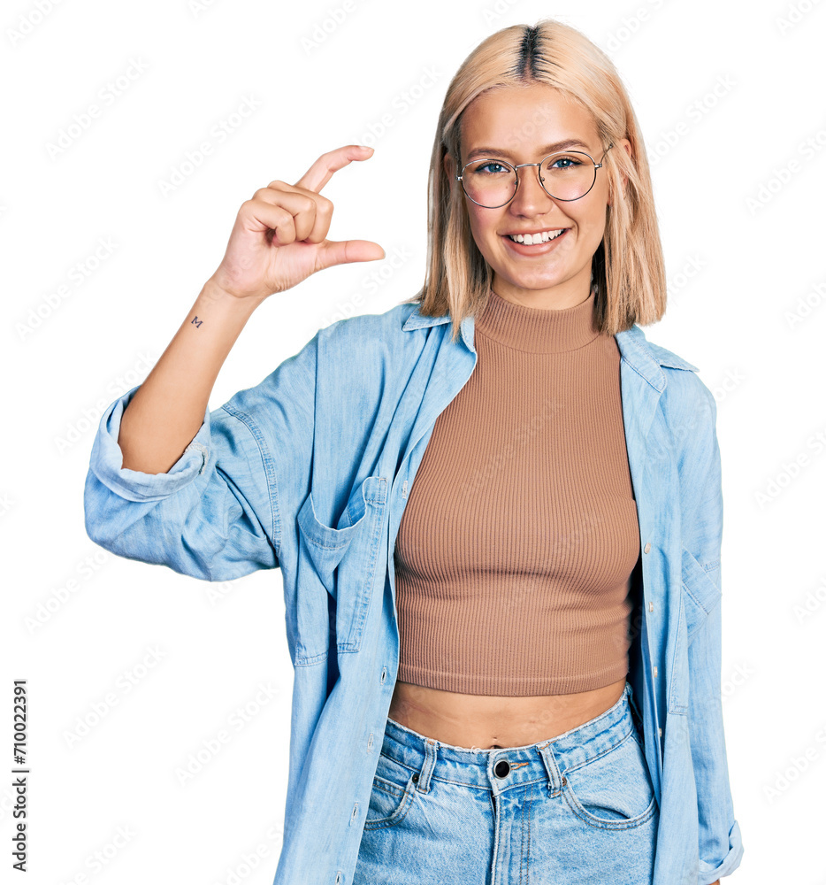 Sticker beautiful young blonde woman wearing glasses smiling and confident gesturing with hand doing small s