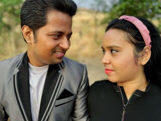 Affectionate couple sharing Love a looking each other with natural backdrop