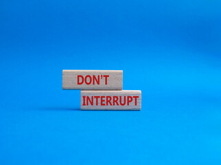 Dont interrupt symbol. Concept word Dont interrupt on wooden blocks. Beautiful blue background. Business and Dont interrupt concept. Copy space