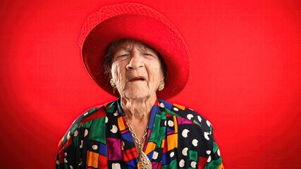 Funny portrait of sick tired headache migraine exhausted elderly mature old woman rubbing temples isolated on red background in studio.