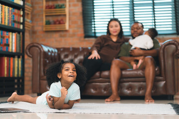 Family enjoy spend wellbeing time together, African father and Asian Mother having a playful time...