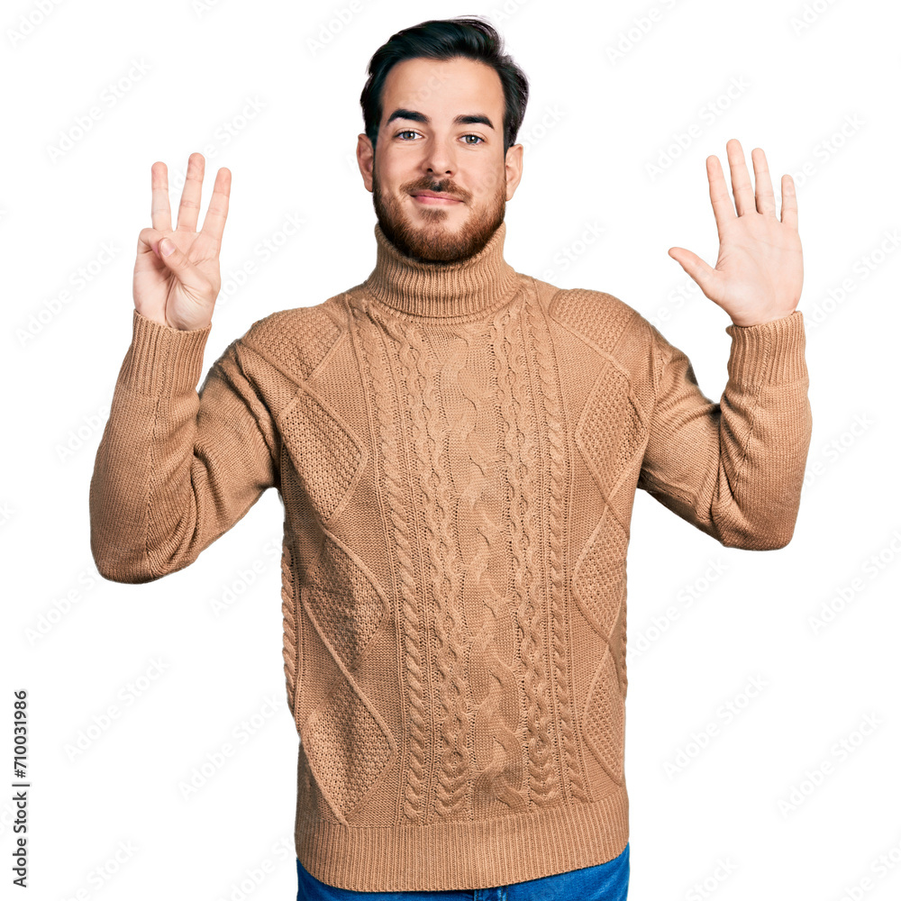 Wall mural Young hispanic man wearing casual clothes showing and pointing up with fingers number eight while smiling confident and happy.