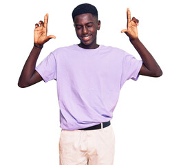 Young african american man wearing casual clothes gesturing finger crossed smiling with hope and eyes closed. luck and superstitious concept.