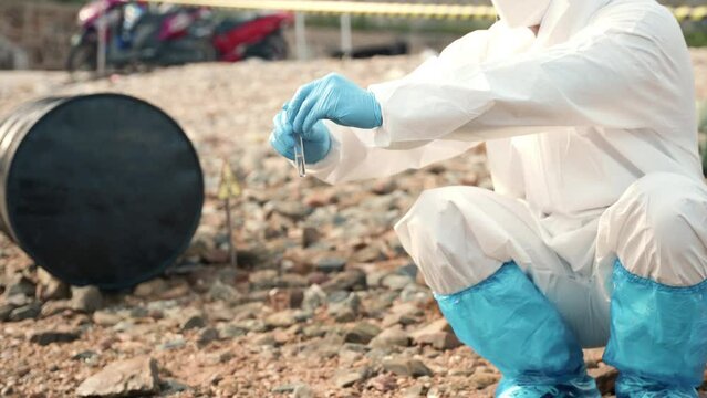 Ecologist sampling water from the river with test tube, Biologist wear protective suit and mask collects sample of waste water from industrial, problem environment, scientist environmentalist