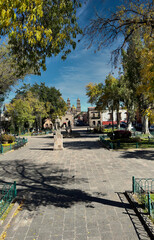 Captivating view of Plaza del Carmen in Morelia, with its colonial charm and vibrant foliage, perfect for cultural and travel themes.