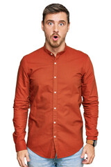 Handsome caucasian man wearing casual clothes afraid and shocked with surprise expression, fear and excited face.