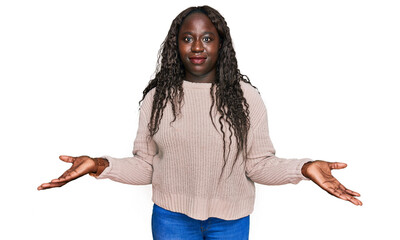 Young african woman wearing wool winter sweater clueless and confused with open arms, no idea...
