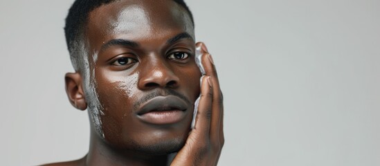 Grooming and skincare for confident African man after cleansing.