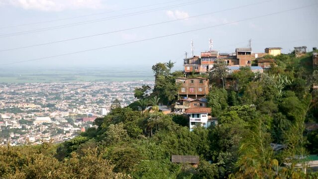 Houses on the hill with a view of Cali, Colombia, Latin America. Cali city in the background. Footage of Cali, South America. High quality 4k footage.