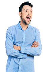 Hispanic man with beard with arms crossed gesture angry and mad screaming frustrated and furious, shouting with anger looking up.