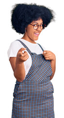 Young african american girl wearing casual clothes pointing fingers to camera with happy and funny face. good energy and vibes.