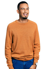 Young african american man wearing casual clothes winking looking at the camera with sexy...