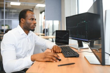 Stock Market Day Trader Working on Computer with Multi-Monitor Workstation with Real-Time...