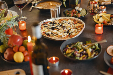 Cozy holiday table setting with different delicious food and beverages ready for friends home party