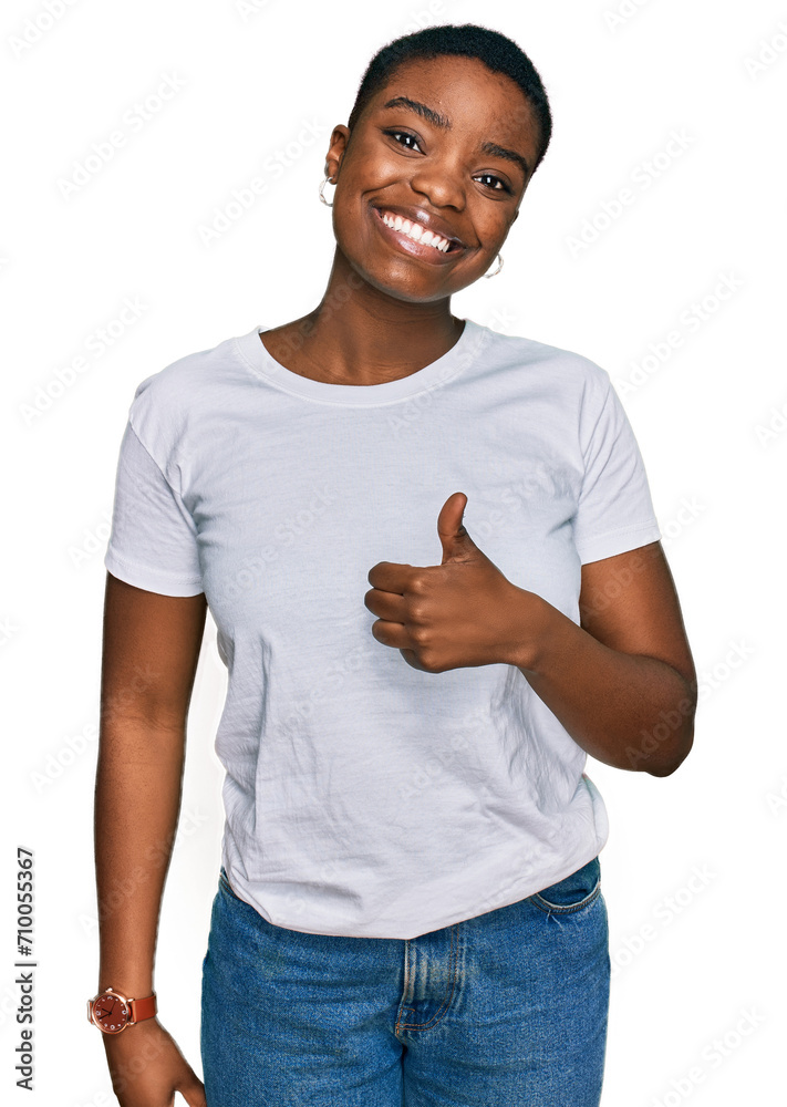 Sticker young african american woman wearing casual white t shirt doing happy thumbs up gesture with hand. a