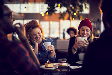 Smiling young diverse people sitting in cafe