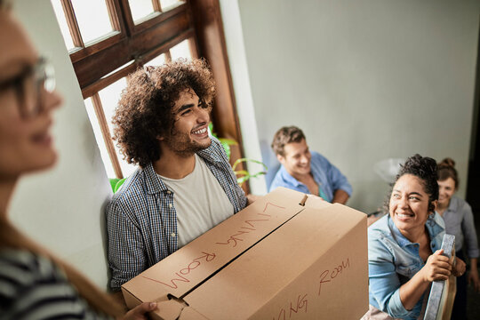 Group of young people moving into their new apartment