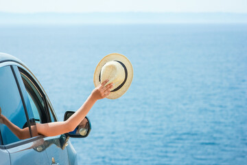 A happy girl from car at sea greece background