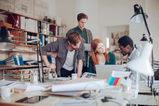 Diverse Young People Collaborating On A Project In A Modern Workspace