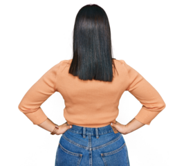 Young hispanic woman wearing casual clothes standing backwards looking away with arms on body