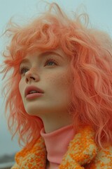 Close up fashion-style street portrait of young woman with peach fuzz colored hair, blue eyes, freckles, natural makeup, wearing peach polo neck and  yellow with orange jacket, low angle