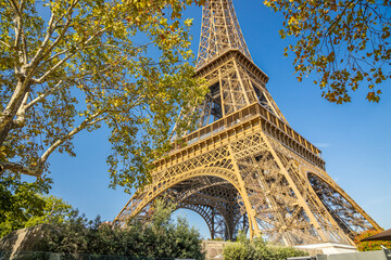 Front of the Eiffel Tower on a sunny summer day with blue sky in Paris, France
