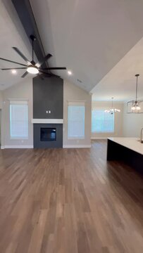 Empty Modern American House Interior with Barn Sliding Doors, Modern Kitchen, Fireplace, Wood Floors Open Space Concept.