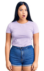 Obraz premium Young beautiful asian girl wearing casual clothes scared and amazed with open mouth for surprise, disbelief face