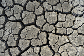 dry and cracked floor of dry river of caldera grande in the city of Barreiro with a small stream.