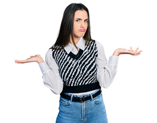 Young brunette teenager wearing casual elegant look clueless and confused with open arms, no idea and doubtful face.