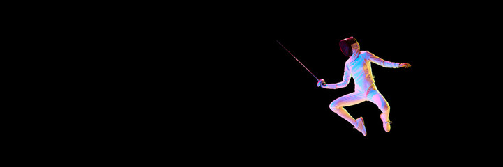 Action and motion. The dynamic motion of an athlete captured in a high-speed photograph. Female fencer training on black background in neon. Banner for ad. Concept of sport, competition, championship