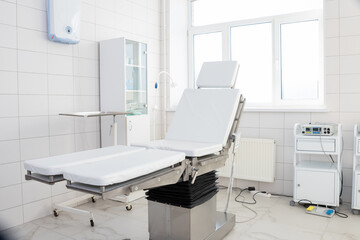 Hospital interior design with operating table and lamp with cabinets and modern devices in light surgery room.modern equipment in the hospital