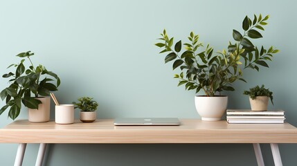 A minimalist workspace with a white wireless keyboard and mouse, a slim laptop, and a potted plant for added freshness - obrazy, fototapety, plakaty