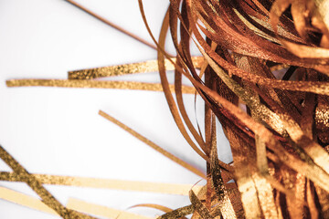 Golden shiny tinsel ribbons. Golden sequins, sparkling stripes of serpentine. Festive decor for new...