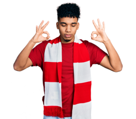 Young african american man football hooligan cheering game relax and smiling with eyes closed doing meditation gesture with fingers. yoga concept.