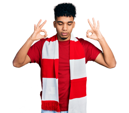 Young african american man football hooligan cheering game relax and smiling with eyes closed doing meditation gesture with fingers. yoga concept.